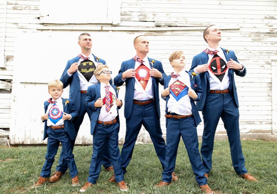 Groom and groomsmen reveal Superman shirts under suits.